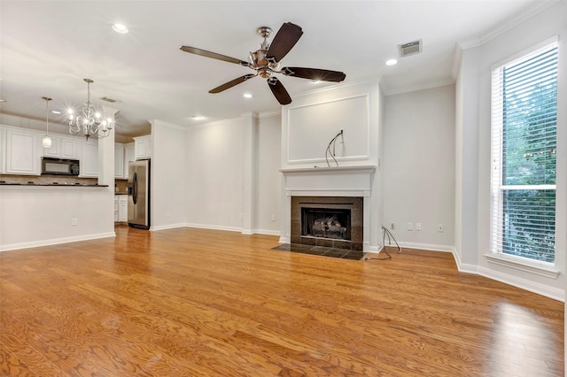 unfurnished living room with light hardwood / wood-style flooring, a fireplace, and ornamental molding