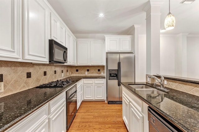 kitchen with sink, white cabinetry, crown molding, hanging light fixtures, and black appliances