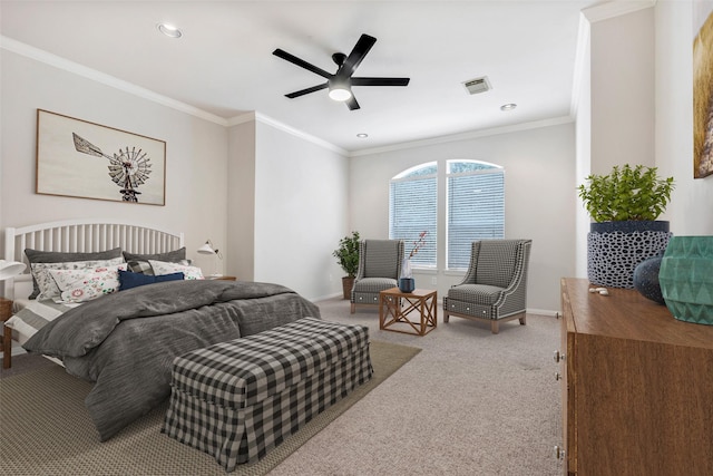 carpeted bedroom with ornamental molding and ceiling fan