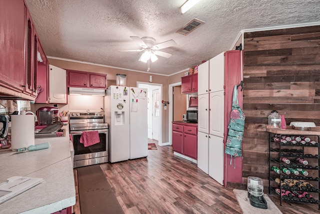 kitchen featuring dark wood-type flooring, ceiling fan, stainless steel range with electric stovetop, white fridge with ice dispenser, and a textured ceiling