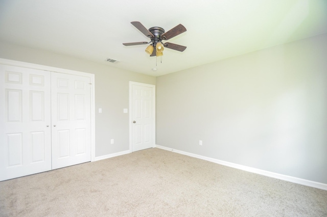 unfurnished bedroom with carpet flooring, ceiling fan, and a closet