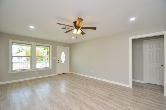 foyer entrance with ceiling fan and light hardwood / wood-style flooring