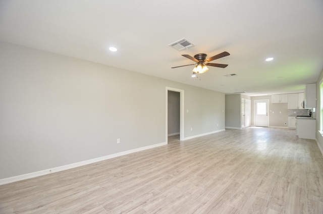 unfurnished living room with ceiling fan and light wood-type flooring