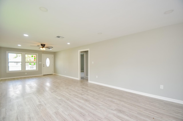 unfurnished living room featuring ceiling fan and light wood-type flooring