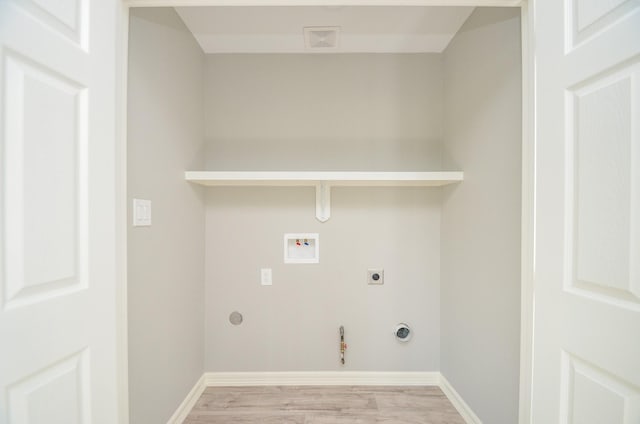 laundry room with gas dryer hookup, washer hookup, light hardwood / wood-style flooring, and hookup for an electric dryer