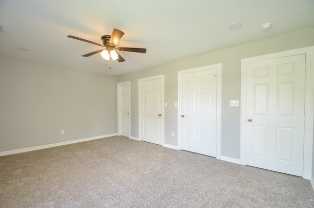 unfurnished bedroom with light carpet and ceiling fan