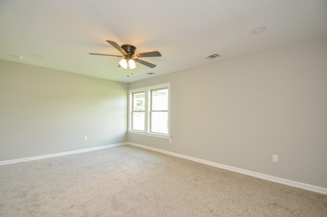 unfurnished room featuring ceiling fan and carpet flooring