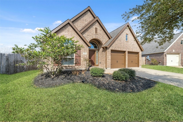 view of front of home with a garage and a front lawn