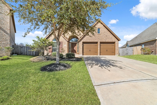 view of front of house featuring a garage and a front lawn