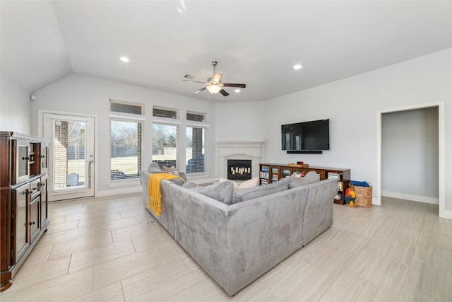 living room featuring vaulted ceiling and ceiling fan