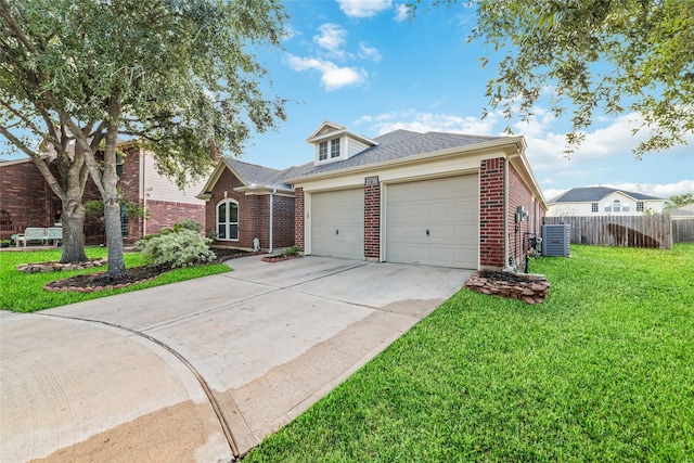 view of front of house featuring a garage, central AC, and a front yard