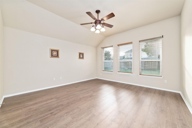 empty room with vaulted ceiling, light hardwood / wood-style floors, and ceiling fan