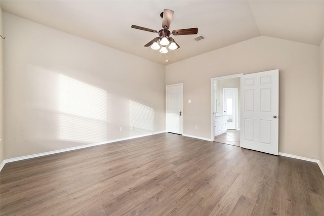 spare room featuring ceiling fan, lofted ceiling, and dark hardwood / wood-style flooring