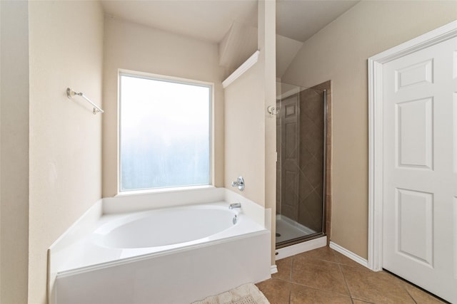 bathroom featuring tile patterned flooring and shower with separate bathtub