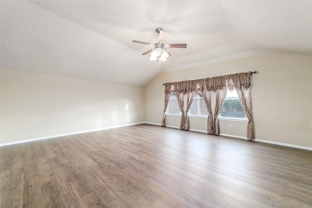 interior space with vaulted ceiling, hardwood / wood-style floors, and ceiling fan