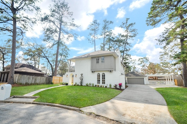 view of front of home with an outbuilding, a balcony, a garage, and a front lawn