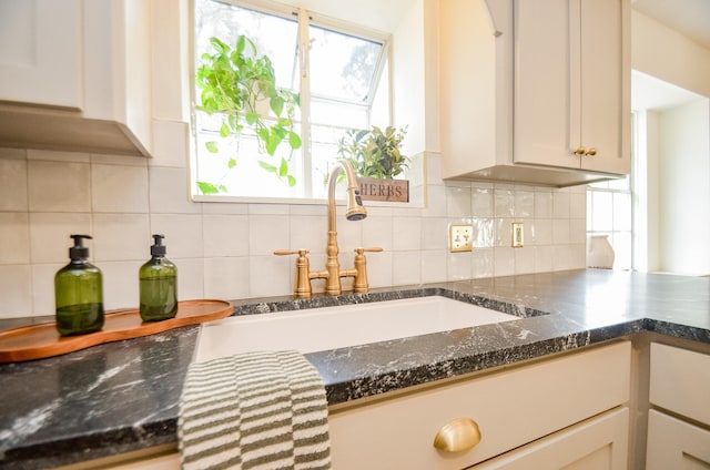 kitchen featuring tasteful backsplash and sink