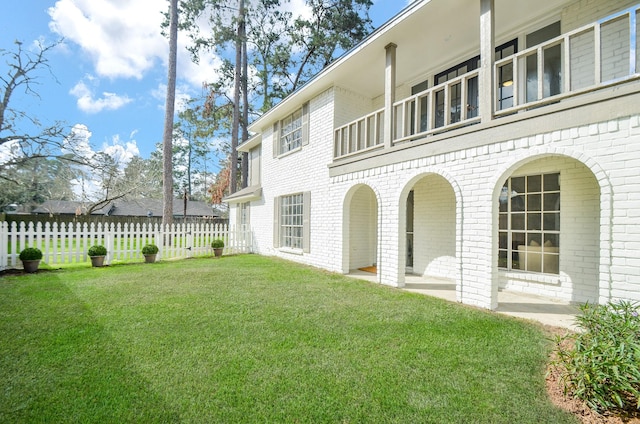 view of yard with a patio and a balcony