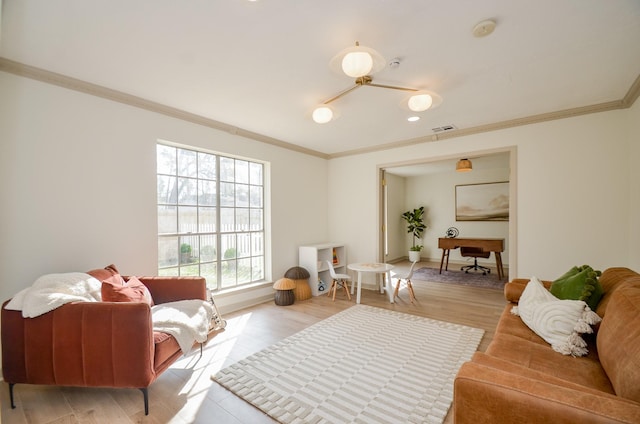 sitting room with ornamental molding and light hardwood / wood-style floors