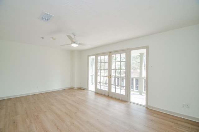 unfurnished room featuring ceiling fan, light wood-type flooring, and french doors