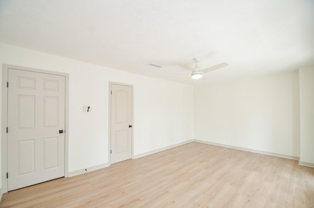 empty room with ceiling fan and light wood-type flooring