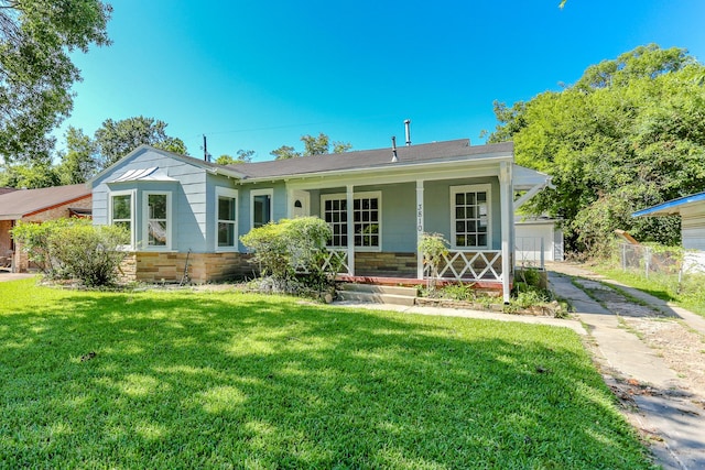 view of front of house with a porch, a garage, and a front yard