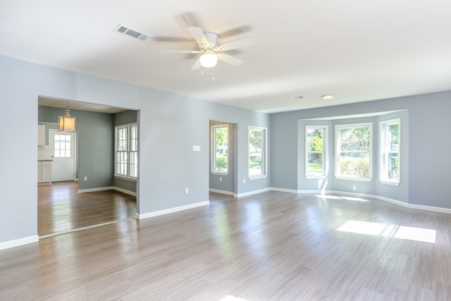 empty room featuring ceiling fan and light hardwood / wood-style flooring