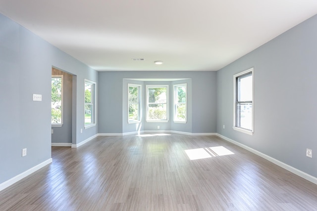 unfurnished room with light wood-type flooring