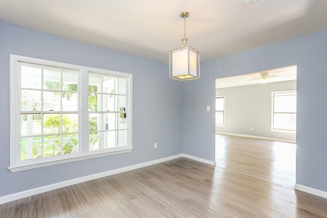 unfurnished room with ceiling fan and light wood-type flooring