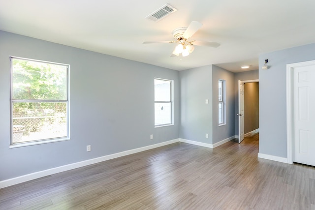 empty room with ceiling fan and hardwood / wood-style floors