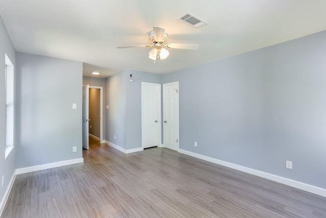 unfurnished room with ceiling fan and light hardwood / wood-style floors