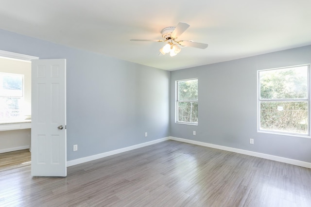 empty room with light hardwood / wood-style flooring and ceiling fan