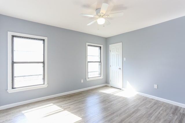 spare room featuring light hardwood / wood-style flooring and ceiling fan