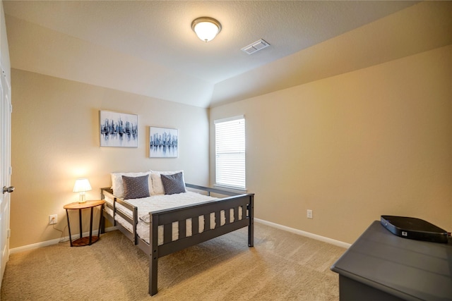 carpeted bedroom featuring vaulted ceiling