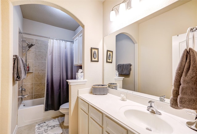 full bathroom featuring shower / bath combo, vanity, a textured ceiling, tile patterned floors, and toilet