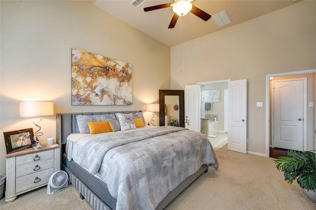 bedroom with ceiling fan, ensuite bathroom, high vaulted ceiling, and carpet