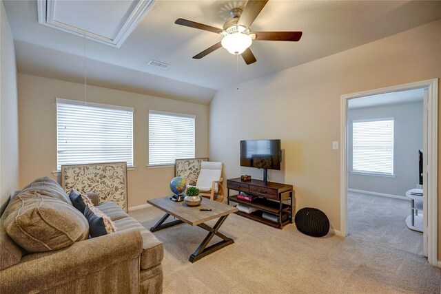 living room featuring vaulted ceiling, light carpet, and ceiling fan