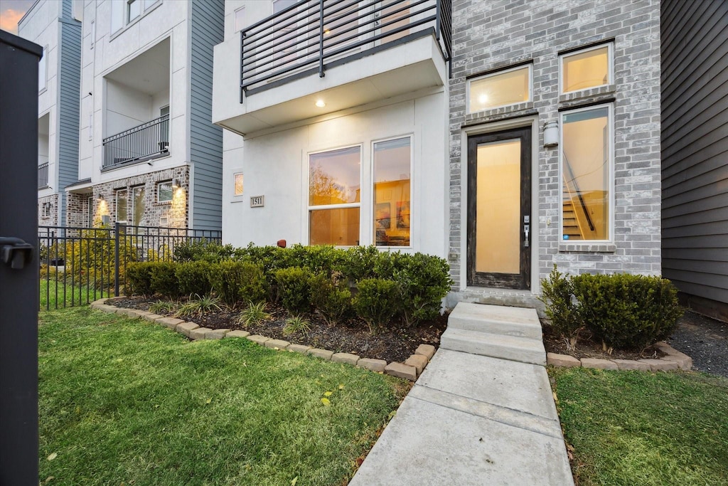 entrance to property with a lawn