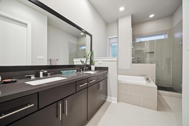 bathroom featuring tile patterned floors, plus walk in shower, and vanity