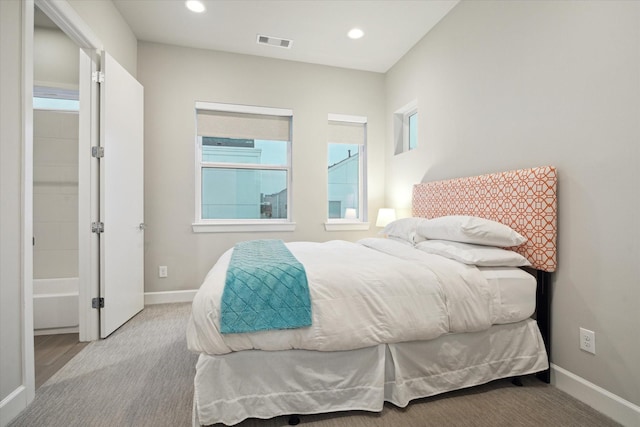 bedroom featuring light carpet