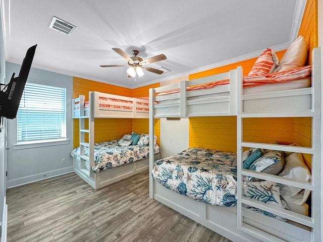 bedroom featuring crown molding, ceiling fan, and hardwood / wood-style floors