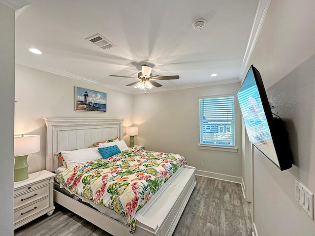 bedroom with ceiling fan, ornamental molding, and dark hardwood / wood-style floors