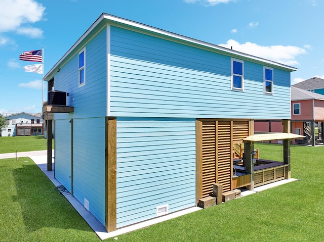 exterior space with cooling unit and a lawn