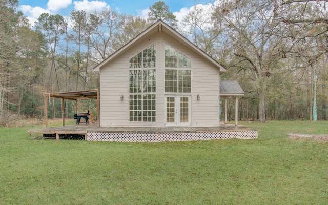 rear view of property featuring a deck and a lawn