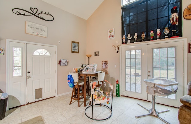 tiled entryway featuring high vaulted ceiling and french doors