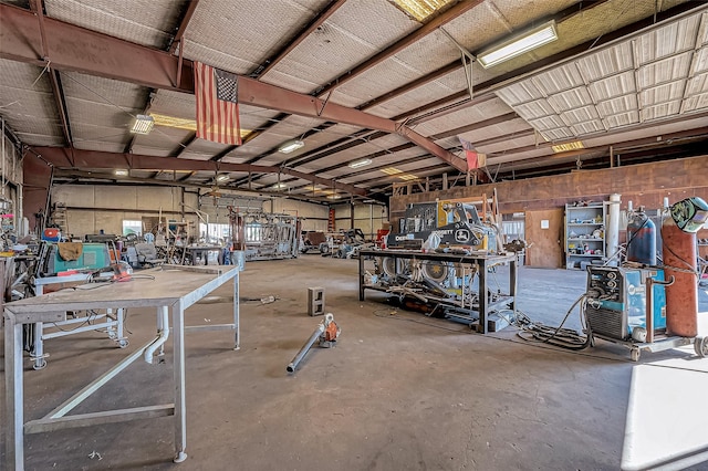 miscellaneous room with concrete flooring and a workshop area