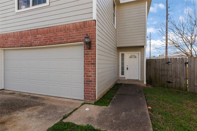 doorway to property with a garage