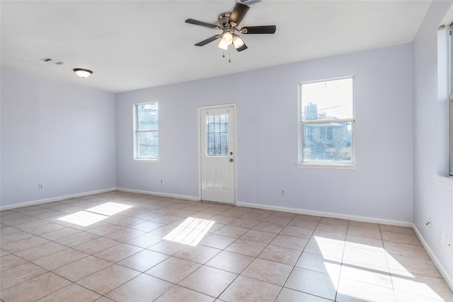 empty room featuring ceiling fan and light tile patterned floors