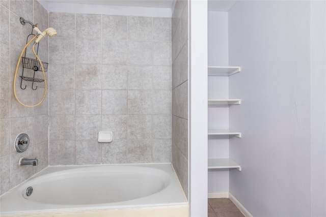 bathroom with tiled shower / bath combo and tile patterned flooring