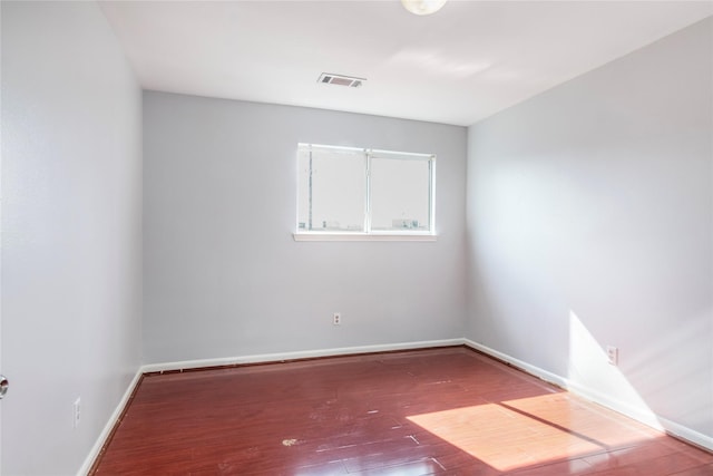 spare room featuring wood-type flooring